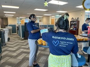 Marketing volunteers pack food for The Kind Mouse