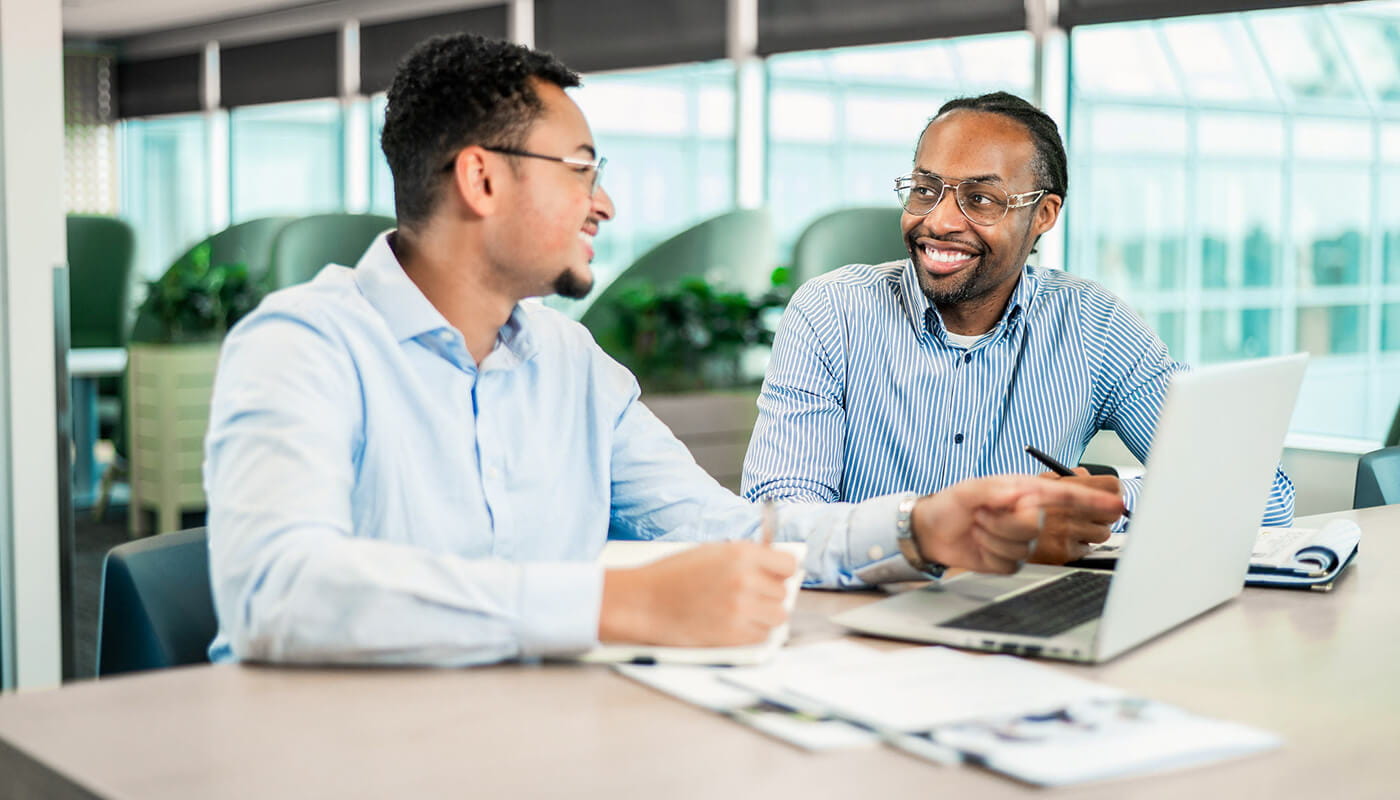Associates working together on a project at their laptop