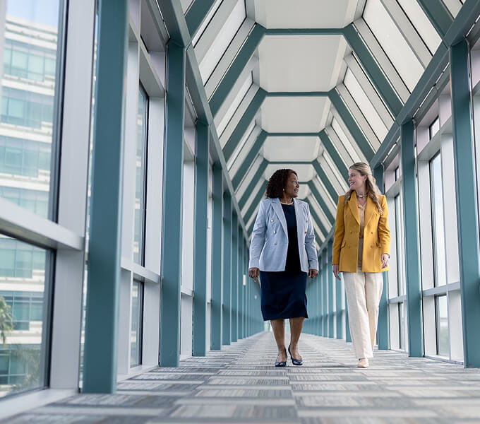 Associates walking together on the skybridge