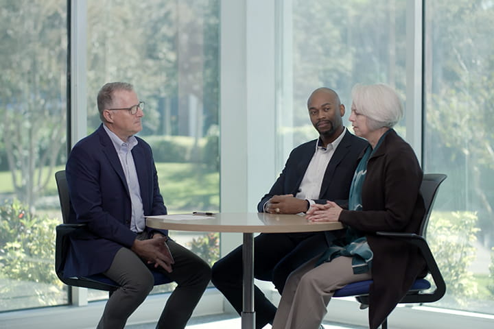 Three military veterans sitting at a roundtable talking